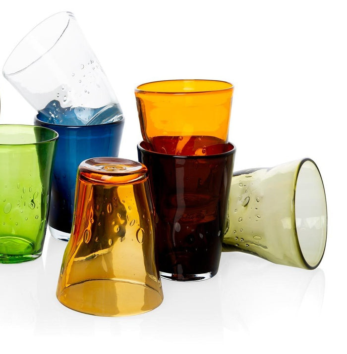 Collection of mouth-blown Henri glasses in clear, olive, amber, blue, and brown, with unique air bubbles.