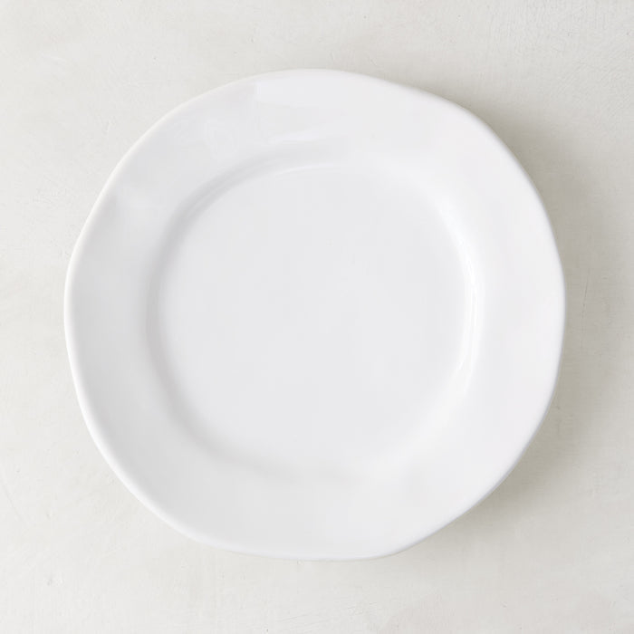 Creamy white ceramic salad plate with subtle organic edges, 9" diameter.