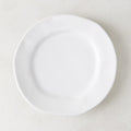 Creamy white ceramic salad plate with subtle organic edges, 9" diameter.