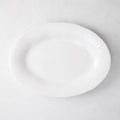 Creamy white oval ceramic serving platter with subtle organic edges.