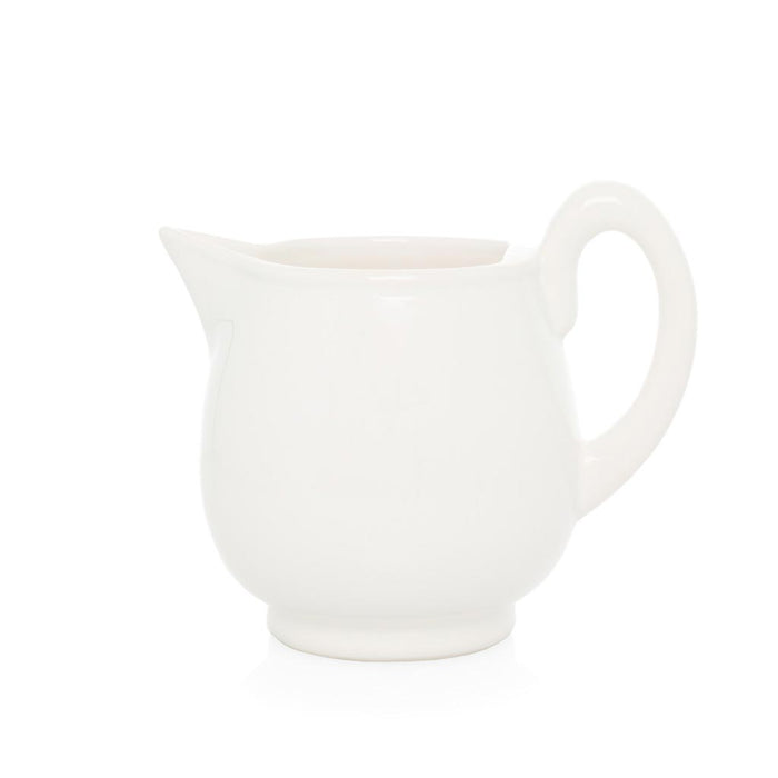 Creamy white ceramic pitcher with handle and angled spout.