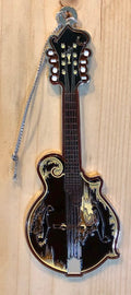 A metal mandolin ornament with a white squirrel and the text 'BREVARD, NC' on the back.