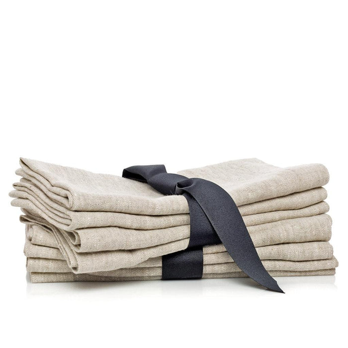 Stack of four oversized natural washed flax linen napkins tied with a dark gray ribbon.
