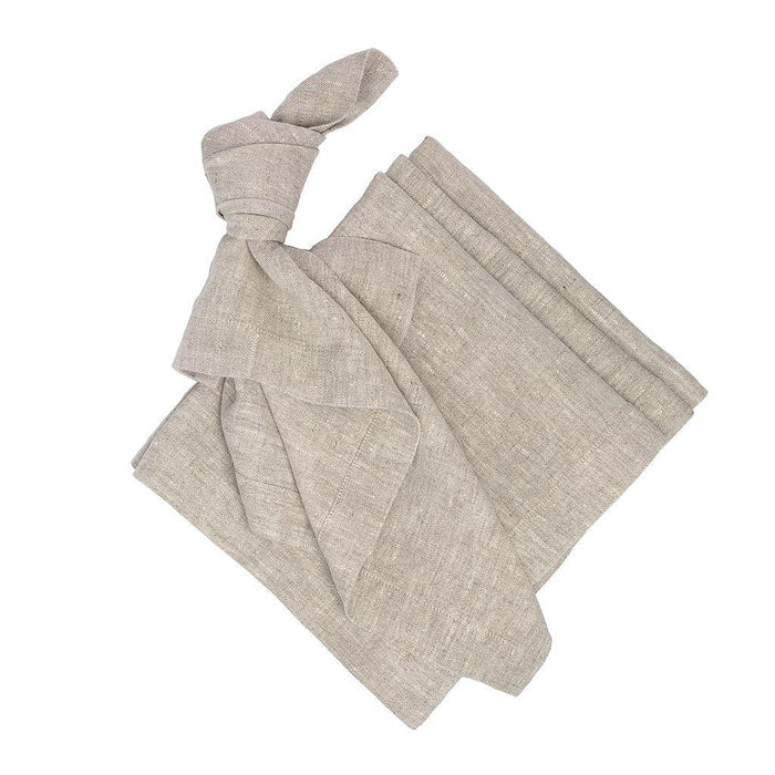 Oversized natural washed flax linen napkins, one tied in a knot, others folded.