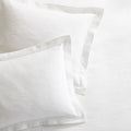 White cotton matelassé shams with subtle paisley pattern and tailored 2-inch hem.