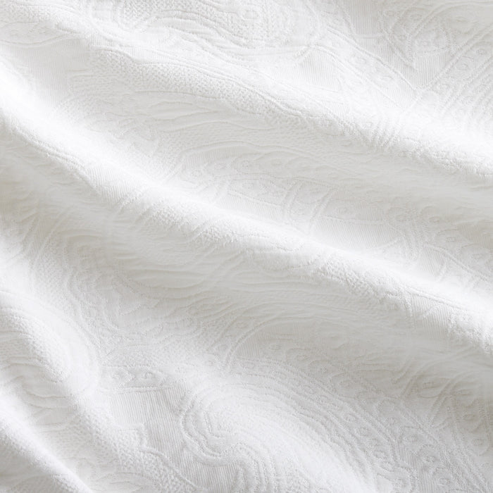 White cotton matelassé sham with subtle paisley pattern and rich texture.