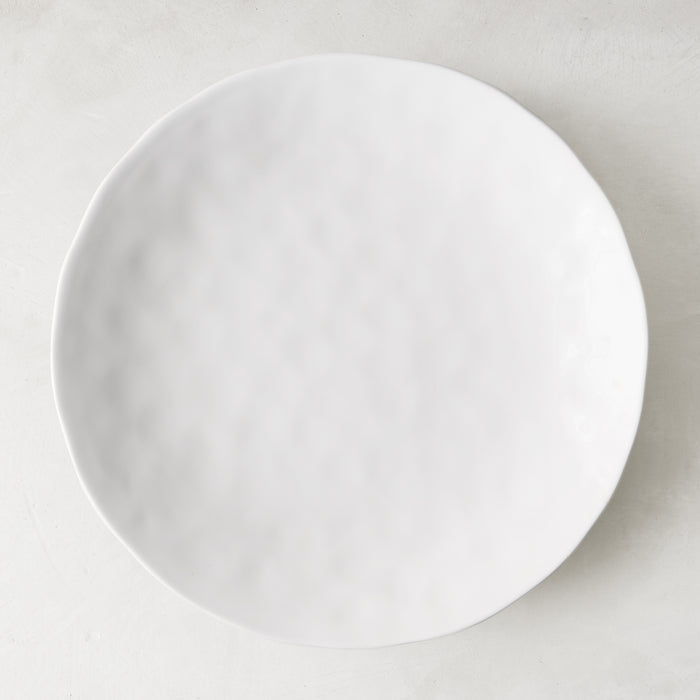 Pebble White 11" ceramic dinner plate with subtle textured surface and creamy white glaze.