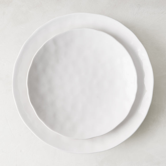 Pebble White ceramic salad plate, 8.5" diameter, with subtle texture, stacked on a larger white plate.