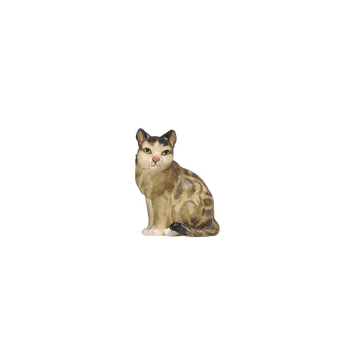 Hand-carved PEMA Kostner nativity cat sitting with two-tone brown and white finish, looking left with tail wrapped around body.
