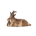 Hand-carved PEMA Kostner nativity goat lying down with two kids wearing small bell collars, made from sycamore maple and oil-painted, crafted in Val Gardena, Italy.