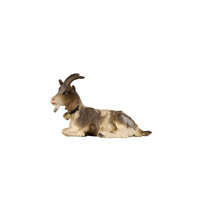 Hand-carved PEMA Kostner nativity goat lying down with horns, bell collar, goatee, and two-tone white and brown fur, crafted in Val Gardena, Italy.