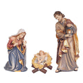 Hand-carved PEMA Kostner Holy Family with Mary kneeling, Joseph standing with lantern, and Infant Jesus removable from a straw-lined manger, crafted in Val Gardena, Italy.