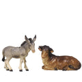 Hand-carved PEMA Kostner nativity ox lying down and donkey standing, made from sycamore maple and oil-painted, crafted in Val Gardena, Italy.