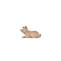 Hand-carved PEMA Kostner nativity piglet lying down in a resting pose, painted in soft pink tones.