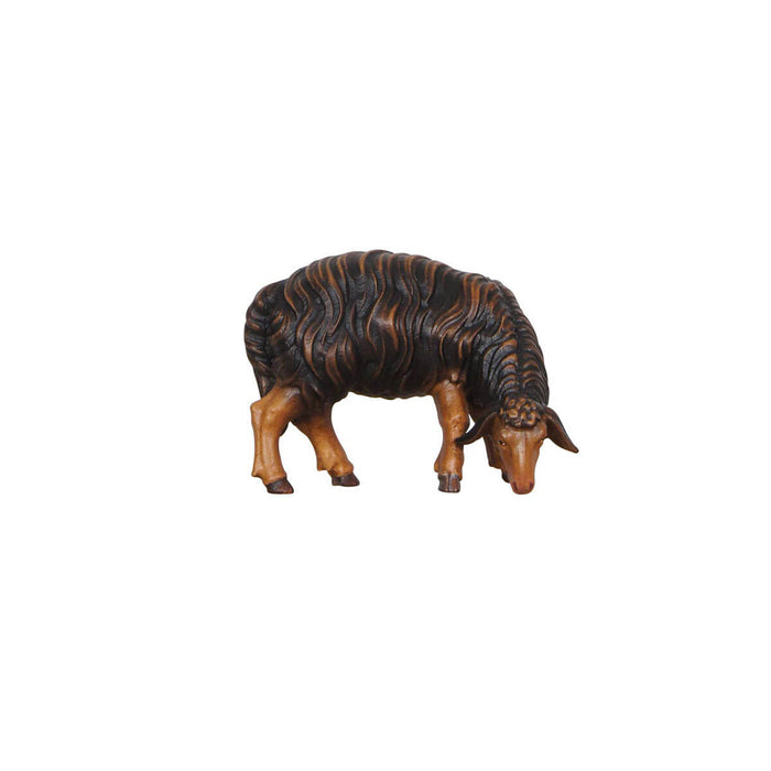 Hand-carved PEMA Kostner nativity black sheep grazing with head lowered and looking right, crafted from sycamore maple and oil-painted in Val Gardena, Italy.