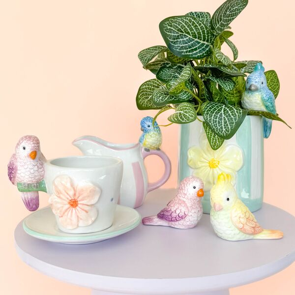 Decorative items including a pitcher, saucer, and bird figurines