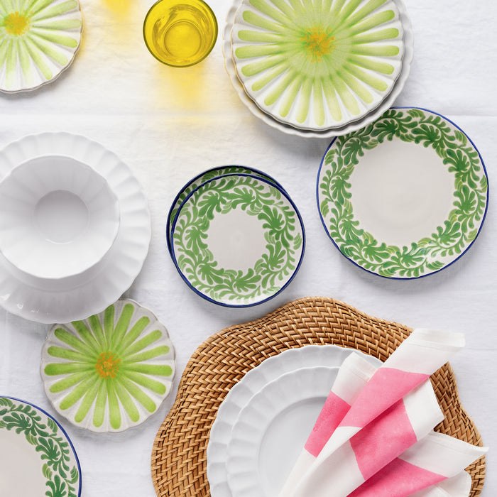 White Petal Stoneware Bowl with matching dinnerware, green patterned plates, and a woven placemat.
