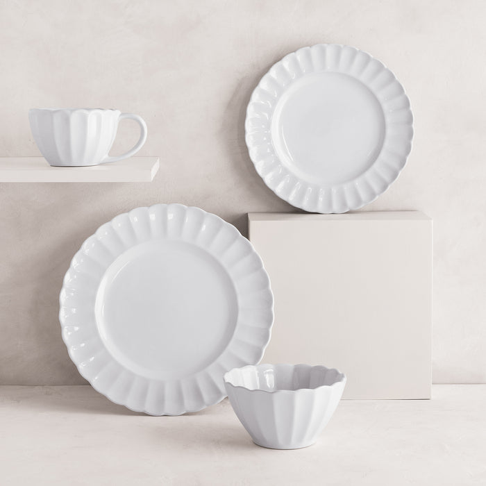 White Petal Stoneware Bowl, two dinner plates, and a matching cup with ruffled edges.