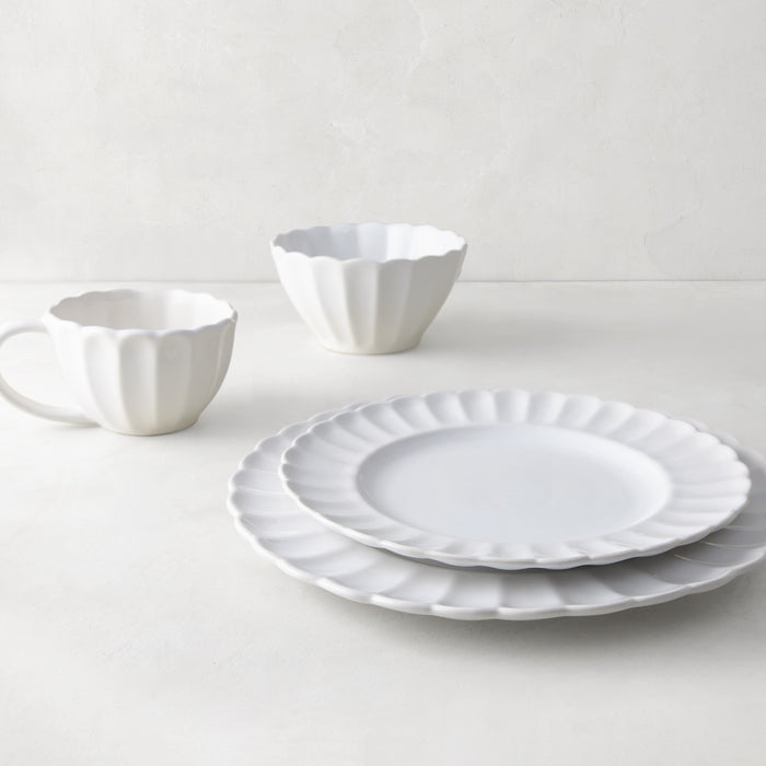 White Petal Stoneware Bowl, dinner plate, salad plate, and mug with scalloped edges.