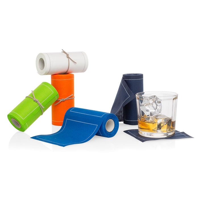 Rolls of petrol blue, orange, lime green, and white tear-off cotton cocktail napkins with a drink glass.