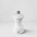 Peugeot Bistro 4" matte white wooden salt mill with a silver-toned finial.