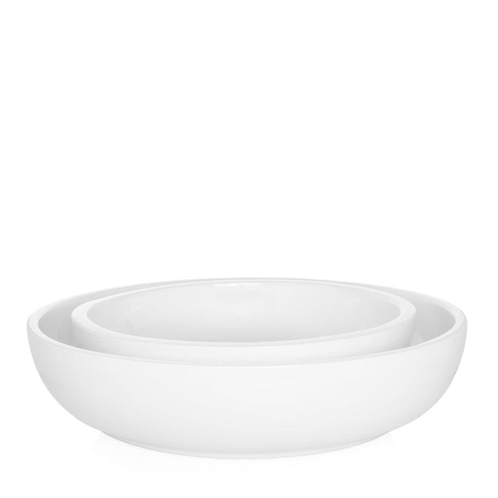 Two nested white ceramic serve bowls, Piatto Riso Large and smaller size, with sleek, simple design.