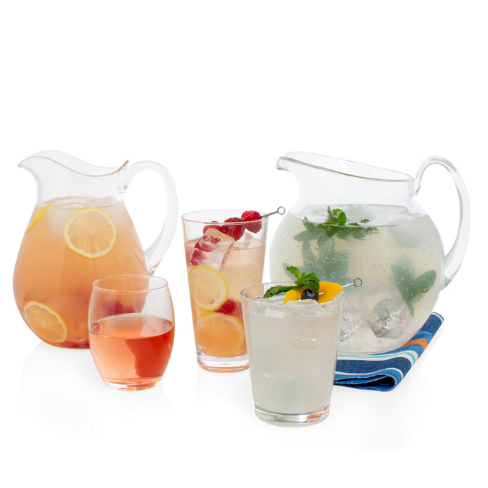 Clear acrylic double old-fashioned glass, 14oz, filled with a light drink, next to other summer beverages.
