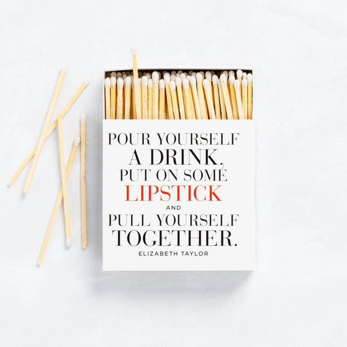 White boxed matches with "Pour Yourself a Drink, Put on Some Lipstick..." quote, featuring long natural wood sticks.