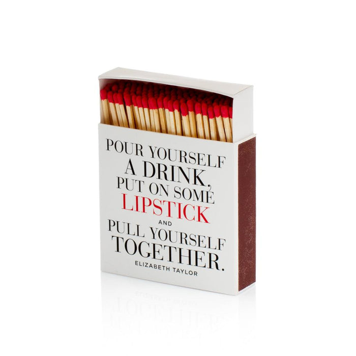 White boxed matches with "Pour yourself a drink, put on some lipstick..." quote, red match tips visible.