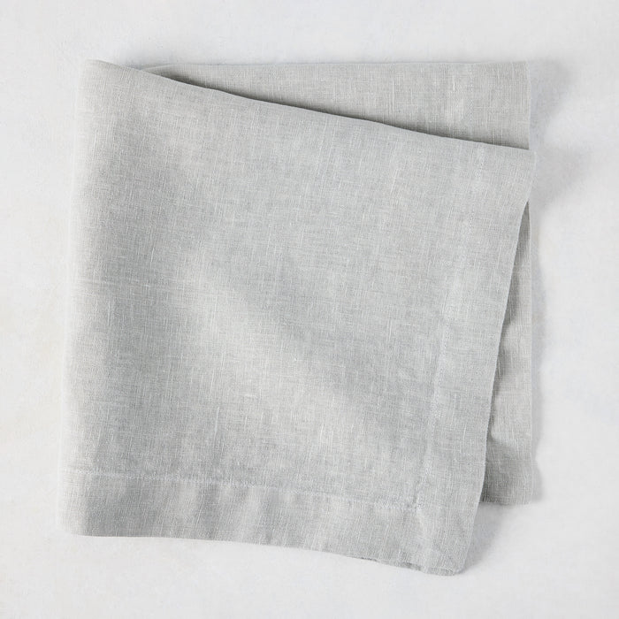 Rain HG Signature hand-dyed light grey linen napkin, 22-inch square, folded.