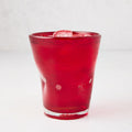 Red Henri 8 oz. mouth-blown glass with ice, showing unique imperfections and air bubbles.