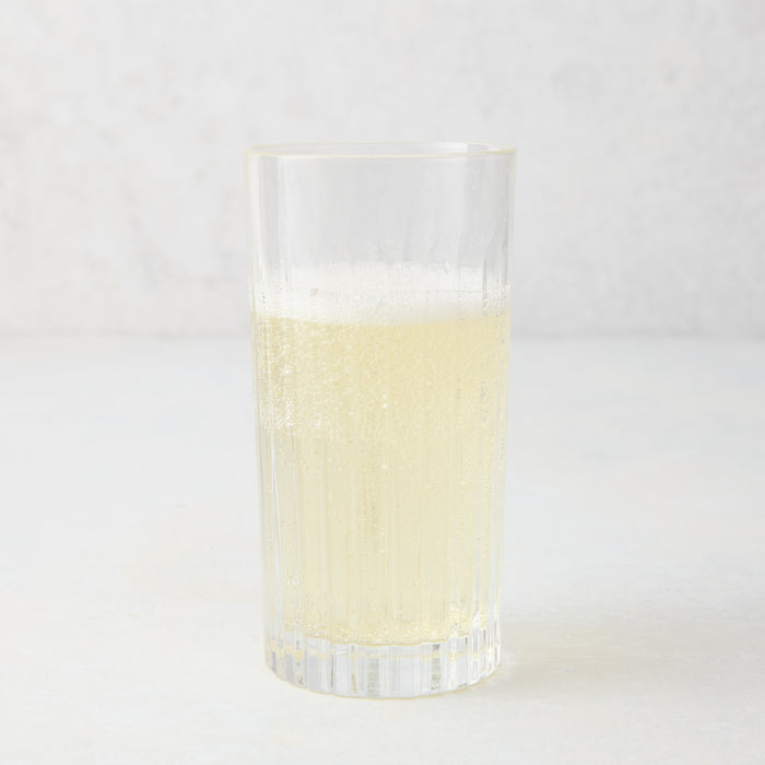 Regent Eco-Crystal High Ball Glass, clear, sleek, slender, with a bubbly light yellow drink.