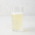 Regent Eco-Crystal High Ball Glass, clear, sleek, slender, with a bubbly light yellow drink.