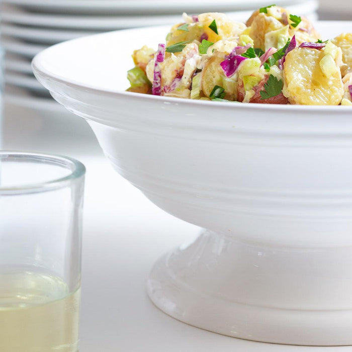 White ceramic footed bowl, 11.5"Dia x 6"H, filled with potato salad.