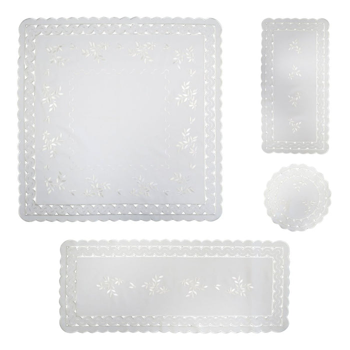 White linen table set with leaf tendril embroidery including square tablecloth, table runner, and round doily with scalloped cutwork edges