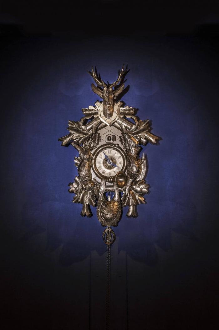 Traditional clock with antique-style clock dial on royal blue background.