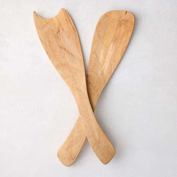 Rustic spalted maple wood salad servers, light brown with unique grain patterns, crossed on white.