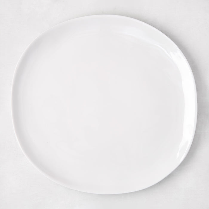 Sandia White 11" round melamine dinner plate with matte exterior and glossy interior.
