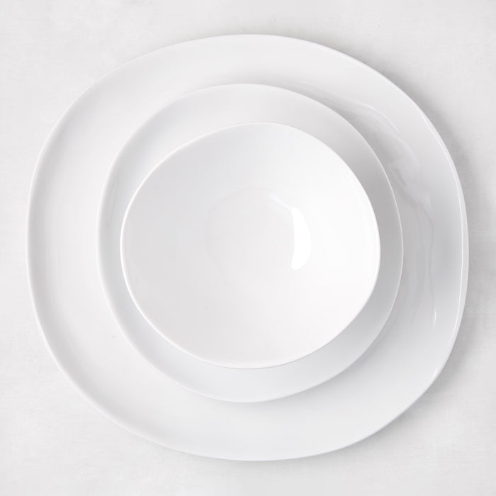 Sandia White 11" melamine dinner plate with organic, hand-thrown-inspired curves, matte exterior, glossy interior.