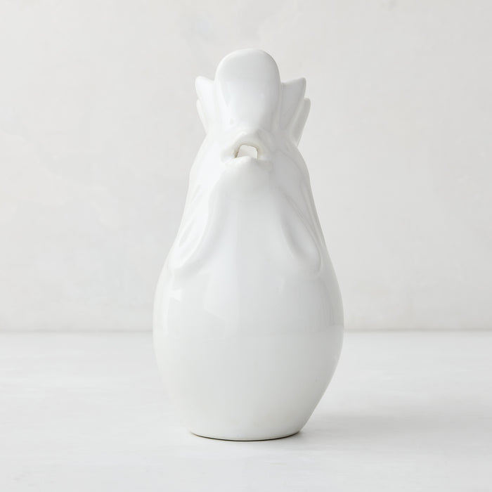 White ceramic rooster pitcher, 6.75"H, with a glossy glaze and detailed head.