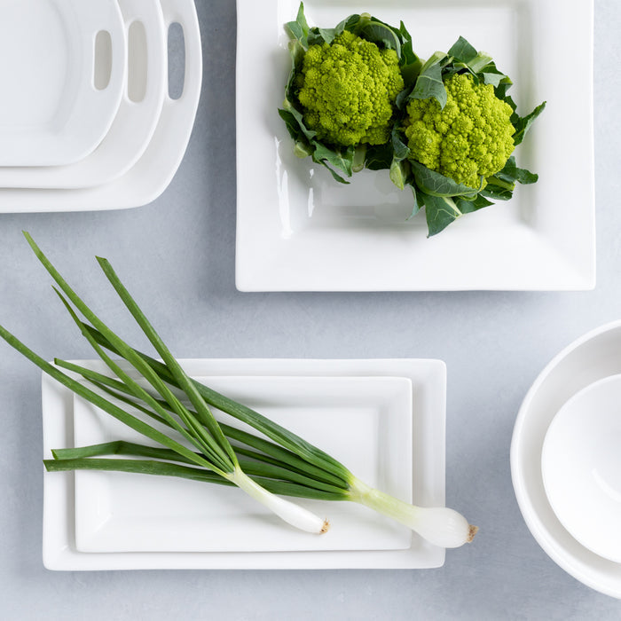 White ceramic Lucca rectangular serving platter with green Romanesco broccoli and scallions.
