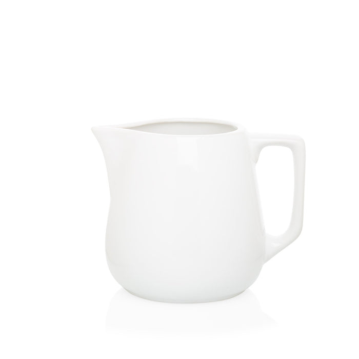 Small white ceramic milk pitcher with handle and spout, 5.5"H x 6.5"W.