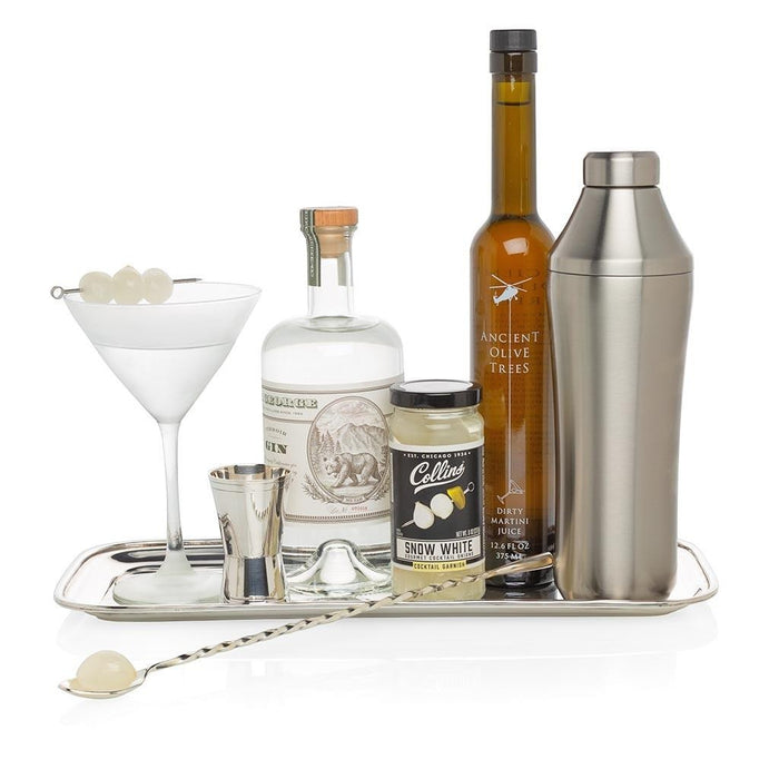Snow White Cocktail Onions in a jar, with gin, olive brine, a martini, and bar tools on a silver tray.