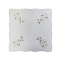 White square table linen with embroidered Christmas bells and holly corner design