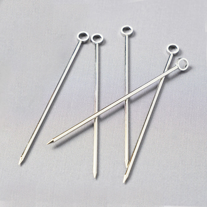 Set of six silver stainless steel cocktail picks, 3.75"L, with a ring top design.