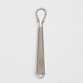 Stainless steel 8"L x 2"W mini whisk with a coiled spring head and loop handle.
