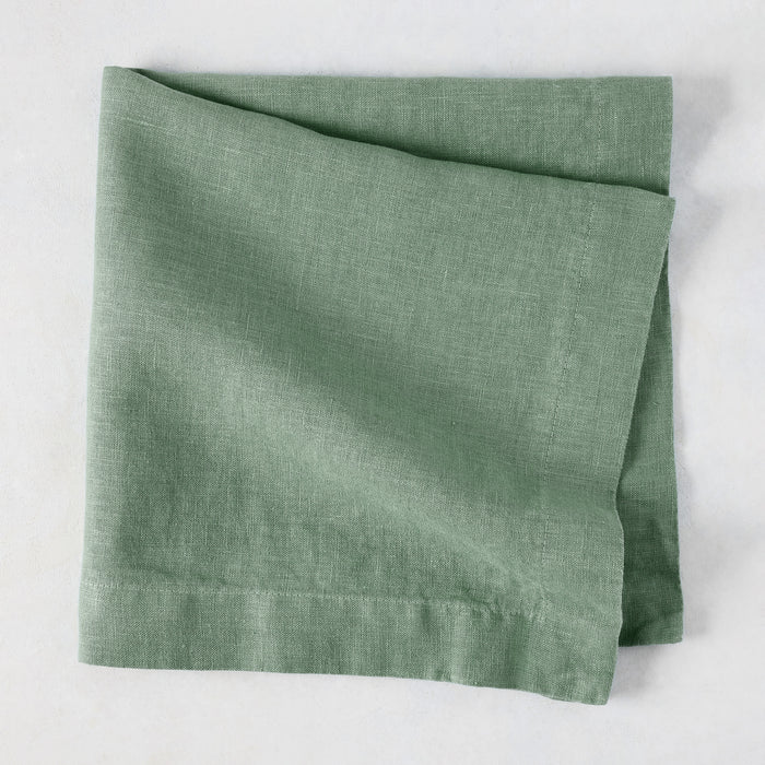 Swiss Chard HG Signature hand-dyed sage green linen napkin, folded, with visible texture and mitered corners.