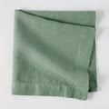 Swiss Chard HG Signature hand-dyed sage green linen napkin, folded, with visible texture and mitered corners.