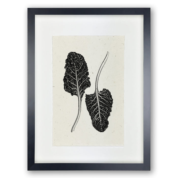 Black framed Swiss Chard handmade paper wall art print, featuring two dark leaves on light textured paper.