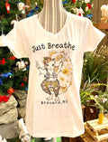 A white short sleeve fitted v-neck t-shirt for ladies with a graphic design of a hippie white squirrel girl and the text 'Just Breathe Brevard,NC'.